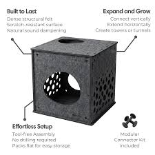 A black metal 3D geometric tower kit shown with callout labels explaining features like built-in to last, effortless setup, and expand and grow. The image includes a central black metal frame with a circular cutout and a smaller black circular insert, surrounded by white text labels on a light gray background.
